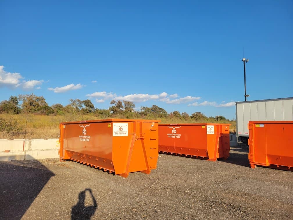 three dumpsters in storage yard